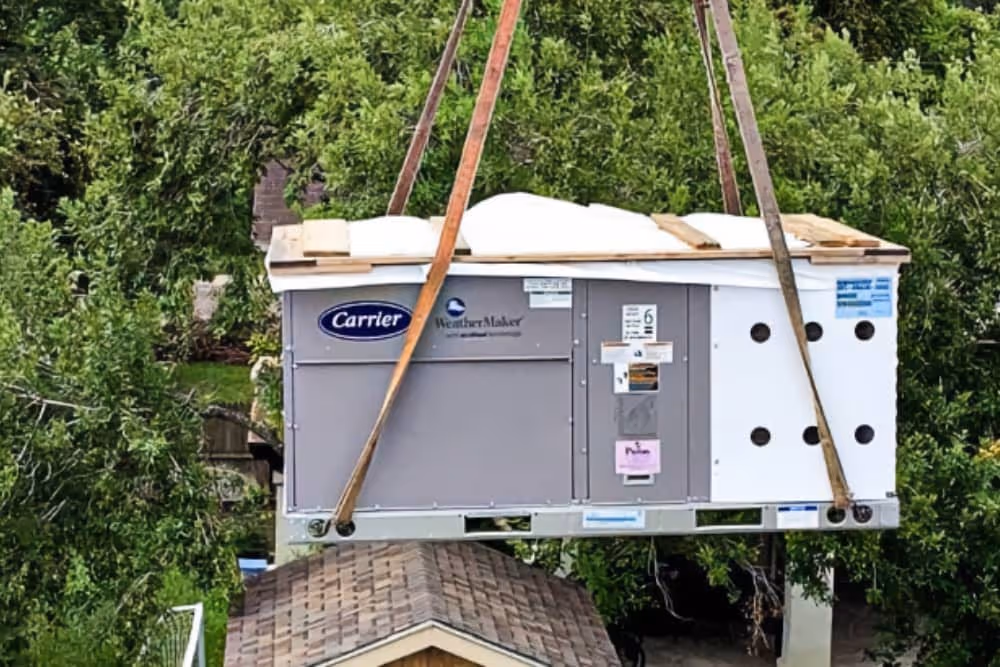air conditioning unit being crane lifted for a residential install in Brownsville, TX