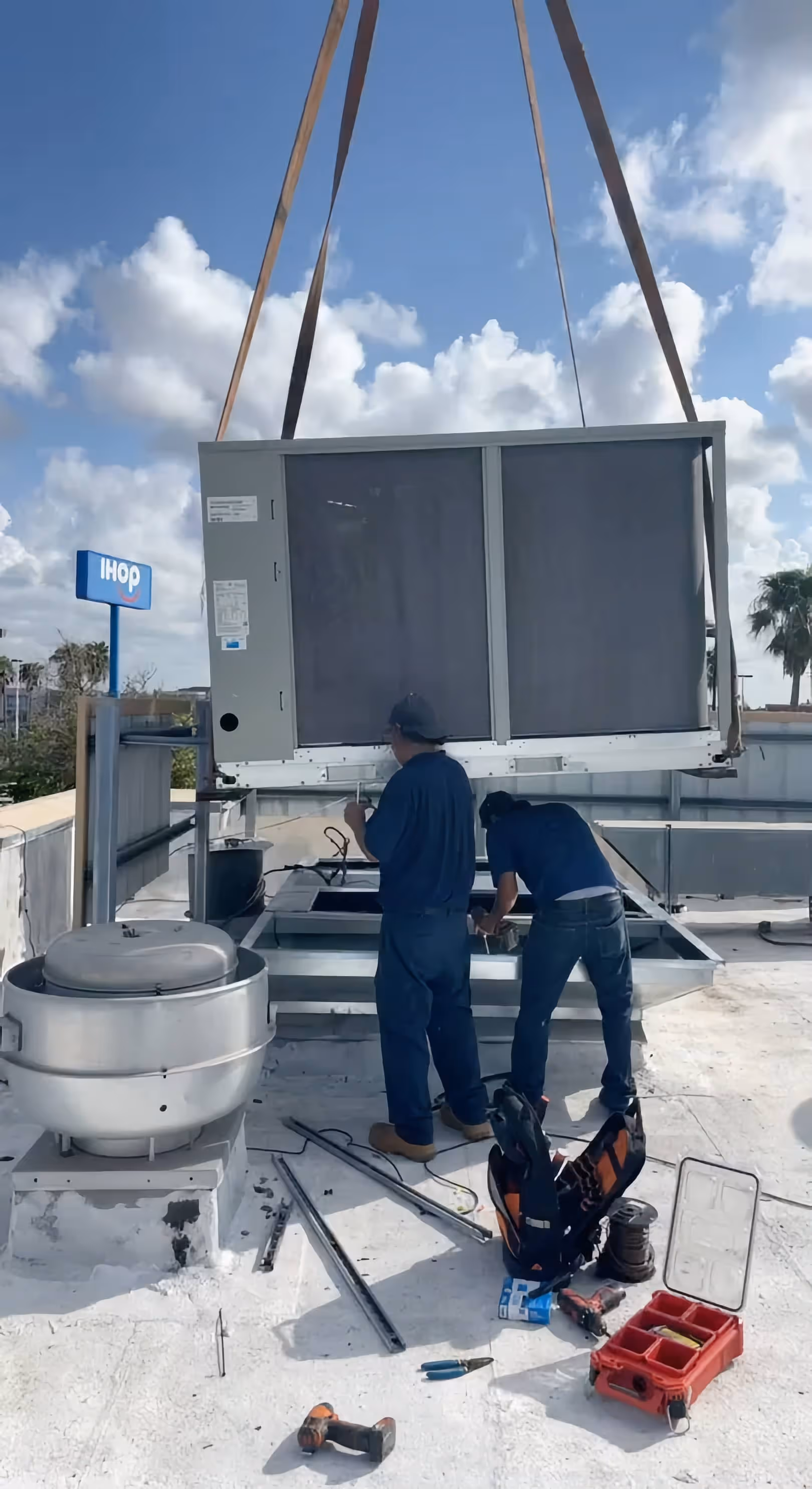 texas lone star ac & heating certified technicians installing an ac on a rooftop in Brownsville, TX